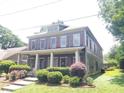 Two-story house with gray siding, red shutters, and a landscaped front yard at 1520 Vassar Ave, College Park, GA 30337