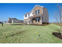 Two-story home showcasing brick and white siding, situated on a grassy lot at 177 Delilah St, Mcdonough, GA 30252