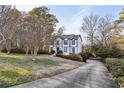 House exterior showcasing a driveway and landscaping at 3007 Winding Sw Way, Lilburn, GA 30047