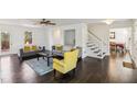 Living room with hardwood floors, gray sofas, and a yellow accent chair at 3007 Winding Sw Way, Lilburn, GA 30047