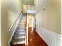 Two-story entryway with hardwood floors and a staircase at 307 Creek Manor Way, Suwanee, GA 30024