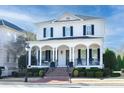 Two-story white brick home with black shutters, a large front porch, and a brick walkway at 3998 St Georges Ct, Duluth, GA 30096