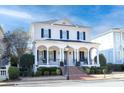 Two-story white brick home with black shutters, a large front porch, and a brick walkway at 3998 St Georges Ct, Duluth, GA 30096