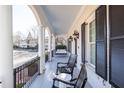 Relaxing front porch with a swing and rocking chairs, offering a view of the neighborhood at 3998 St Georges Ct, Duluth, GA 30096