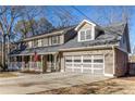 Two-story house with gray siding, white porch, and a two-car garage at 820 Oak Ter, Norcross, GA 30071