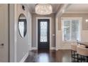 Elegant entry with hardwood floors, chandelier, and round mirror at 2465 Henderson Rd, Tucker, GA 30084