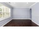 Simple dining room with dark hardwood floors and wainscoting at 1598 Blue Spruce Ln, Conyers, GA 30012
