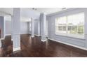 Spacious living room with hardwood floors and neutral walls at 1598 Blue Spruce Ln, Conyers, GA 30012