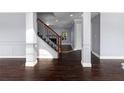 Dark hardwood floors and a modern staircase in a home at 1598 Blue Spruce Ln, Conyers, GA 30012