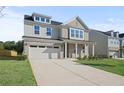 Two-story house with attached garage and landscaping at 305 Foxglove Way, Mcdonough, GA 30253