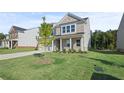 Two-story house with a spacious lawn and tree at 305 Foxglove Way, Mcdonough, GA 30253