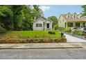 House with a stone wall and driveway, beautiful landscaping at 1382 Elizabeth Ln, East Point, GA 30344