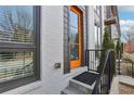 Modern townhouse with orange front door and black metal railings at 457 Parkway Ne Dr, Atlanta, GA 30308