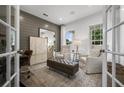 Bright office with wood floors, french doors, and comfortable seating at 344 Foxglove Way, Mcdonough, GA 30253
