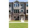 Front view of a modern townhouse with stone accents and a white door at 3794 Jack Vernon Cir, Powder Springs, GA 30127