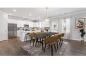 Modern kitchen with island, stainless steel appliances, and dining area at 440 Dahlia St, Mcdonough, GA 30253