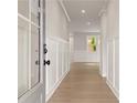 Bright foyer featuring white walls, board and batten trim, and wood-look floors leading to the living area at 715 Crossroad Ct, Powder Springs, GA 30127