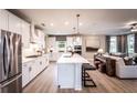 Open concept kitchen with island, white cabinets, and stainless steel appliances at 715 Crossroad Ct, Powder Springs, GA 30127
