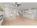 Bright, open-concept living room with a fireplace and direct access to the modern kitchen and backyard at 715 Crossroad Ct, Powder Springs, GA 30127