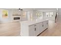 Open-concept living room featuring a modern electric fireplace and a spacious kitchen island at 715 Crossroad Ct, Powder Springs, GA 30127