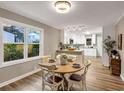 Cozy dining area with a round table, wood floors, and lots of natural light from a nearby window at 2068 Verbena Nw St, Atlanta, GA 30314