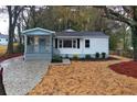 Charming home with white siding, a welcoming front porch, well-maintained landscaping, and a new driveway at 2068 Verbena Nw St, Atlanta, GA 30314