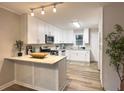 Modern kitchen with white cabinets, granite counters, and stainless steel appliances at 2068 Verbena Nw St, Atlanta, GA 30314