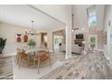 Open-concept dining room featuring modern chandelier and easy access to living spaces, perfect for entertaining at 220 Autumn Brook Dr, Canton, GA 30115
