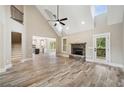 Spacious living room with hardwood floors, a stone fireplace, and vaulted ceilings at 220 Autumn Brook Dr, Canton, GA 30115