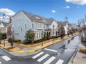 Community of upscale townhouses with a tree-lined street at 228 Dawson Dr, Woodstock, GA 30188