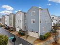 Rear view of townhouses with attached garages and fenced yards at 228 Dawson Dr, Woodstock, GA 30188