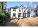Two-story house with white brick, gray accents, and a two-car garage at 3581 Baywater Trl, Snellville, GA 30039