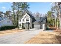 Two-story house with white brick, gray accents, and a two-car garage at 3581 Baywater Trl, Snellville, GA 30039