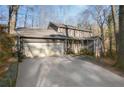 Two-story house with attached garage and driveway, surrounded by mature trees at 4275 Blackland Dr, Marietta, GA 30067