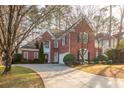 Brick two-story house with a large driveway and landscaping at 510 Park Creek Rdg, Alpharetta, GA 30005