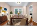 Bright dining room with hardwood floors and large windows at 5823 Button Gwinnett Pl, Norcross, GA 30093