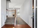 Bright entry hall with hardwood floors and a staircase leading upstairs at 216 Parc View Ln, Woodstock, GA 30188