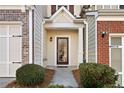 Inviting entryway with a charming brown door and well-maintained landscaping at 216 Parc View Ln, Woodstock, GA 30188