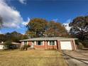 Brick ranch house with a large yard and mature trees at 1261 Cliffwood Se Dr, Smyrna, GA 30080