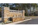 Stone entrance sign for Rosewood Farms community with a water feature at 2456 Bayberry St, Acworth, GA 30101