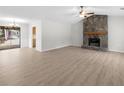 Spacious living room with stone fireplace and laminate flooring at 1237 Torrey Pl, Dacula, GA 30019