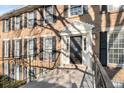 Well-lit entrance with a classic black door, white trim, and wrought-iron railing at 1101 Collier Nw Rd # L3, Atlanta, GA 30318