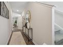 Inviting hallway with wood floors, neutral walls, decorative mirror, and stairway access at 2280 Jamin Bnd # 17, Lithonia, GA 30058