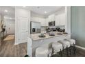 Bright kitchen featuring white cabinetry, stainless steel appliances, and a breakfast bar with seating at 2280 Jamin Bnd # 17, Lithonia, GA 30058