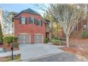 Two-story brick home with two-car garage and driveway at 588 Myrtle Trace Ln, Suwanee, GA 30024