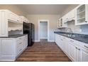 Bright kitchen with white cabinets and dark wood floors at 1453 Graham Sw St, Atlanta, GA 30310