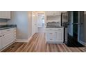 Modern kitchen with white cabinets and black appliances at 1453 Graham Sw St, Atlanta, GA 30310