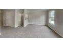 Bright living room with gray carpeting and a view of the backyard at 1699 Redan W, Lithonia, GA 30058