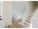 Bright entryway with hardwood floors and staircase at 4850 Streamside Dr, Alpharetta, GA 30022