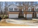 Two-story brick townhouse with a 2-car garage and nicely landscaped yard at 2128 Mill Garden Run, Buford, GA 30519